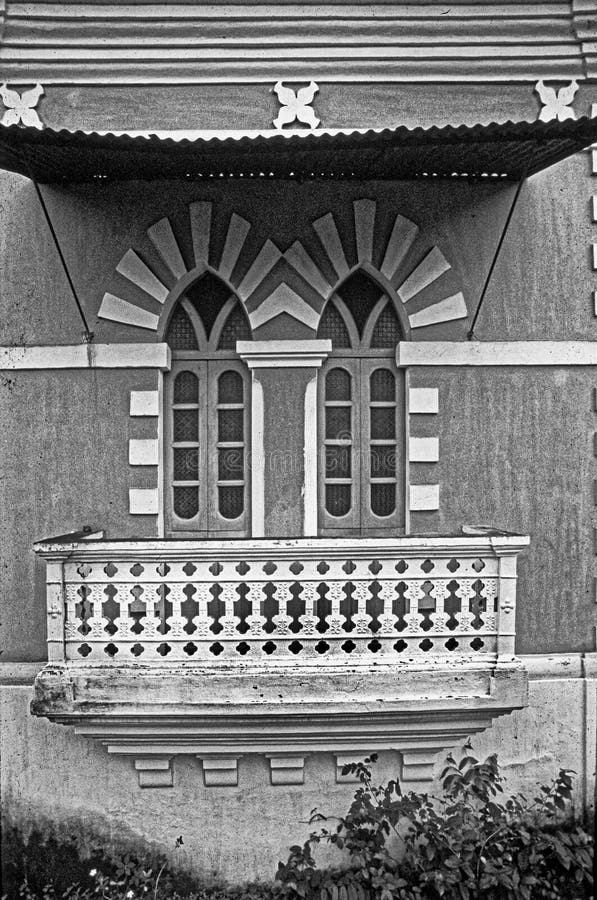 Due porte al balcone e al capanno del tempo della villa dipinta di giallo e bianco fotografia stock libera da diritti