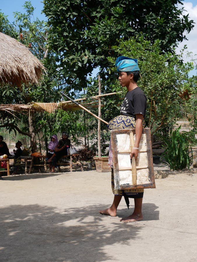 Sade, Lombok/Indonesia-07 29 2018: Two men doing peresean at Sade village. They use a rattan stick braid as a sword, and a shield made of buffalo skin called ende. Sade, Lombok/Indonesia-07 29 2018: Two men doing peresean at Sade village. They use a rattan stick braid as a sword, and a shield made of buffalo skin called ende.