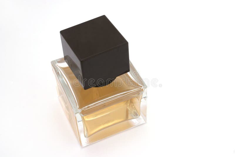 A square perfume bottle with brown cap. A square perfume bottle with brown cap