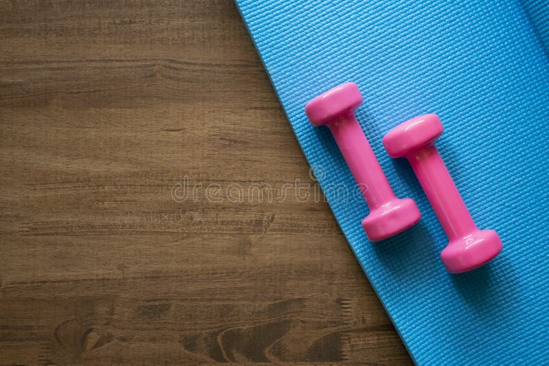 Dumbbell and Yoga Mat on Table Stock Image - Image of wood, exercise ...