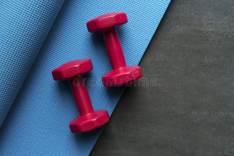Dumbbell and Yoga Mat on Table Stock Image - Image of sport, wood: 97652517