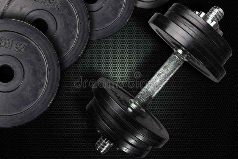 Dumbells i ciężary na węgla tle fotografia royalty free Dumbells i ciężary na węgla tle fotografia royalty free