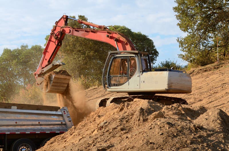 dump-load-track-hoe-excavator-loading-articulated-truck-top-soil-later-use-new-commercial-construction-33761646.jpg