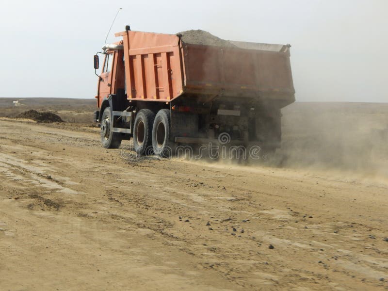 Dump trucks on the road stock image. Image of vehicle 136560691