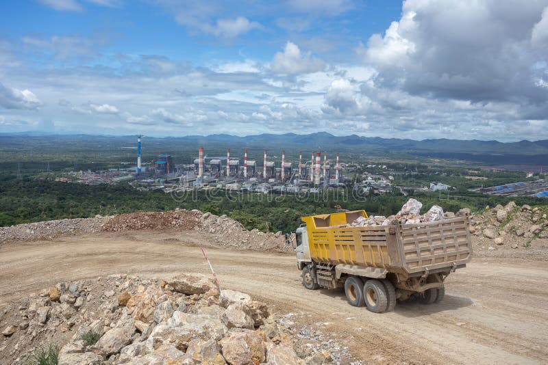 Dumper truck carrying rocks in a quarry. Dumper truck carrying rocks in a quarry