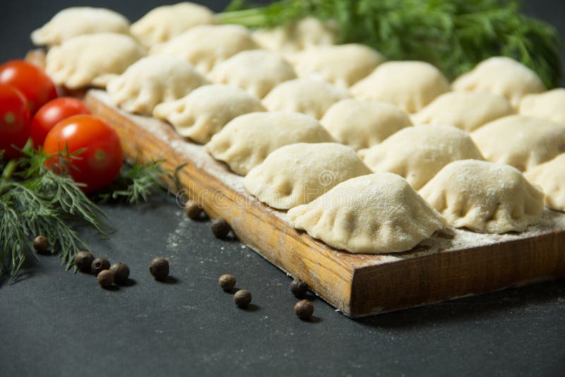Dumplings on a Black Background with Fresh Herbs and Vegetables. Stock Image Image of dough