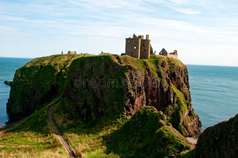 Donnottar Castle, Stonehaven, Aberdeenshire, Scotland, UK, Just out of Stonehaven on the A90. Dunnottar Castle, &#x22;fort on the shelving slope&#x22;&#x29; is a ruined medieval fortress located upon a rocky headland on the northeastern coast of Scotland, about 2 miles &#x28;3.2 km&#x29; south of Stonehaven. The surviving buildings are largely of the 15th and 16th centuries, but the site is believed to have been fortified in the Early Middle Ages. Dunnottar has played a prominent role in the history of Scotland through to the 18th-century Jacobite risings because of its strategic location and defensive strength. Dunnottar is best known as the place where the Honours of Scotland, the Scottish crown jewels, were hidden from Oliver Cromwell&#x27;s invading army in the 17th century. The property of the Keiths from the 14th century, and the seat of the Earl Marischal, Dunnottar declined after the last Earl forfeited his titles by taking part in the Jacobite rebellion of 1715. The castle was restored in the 20th century and is now open to the public. The ruins of the castle are spread over 1.4 hectares &#x28;3.5 acres&#x29;, surrounded by steep cliffs that drop to the North Sea, 160 feet &#x28;49 m&#x29; below. A narrow strip of land joins the headland to the mainland, along which a steep path leads up to the gatehouse. The various buildings within the castle include the 14th-century tower house as well as the 16th-century palace. Dunnottar Castle is a scheduled monument, and