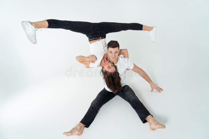 Premium Photo  Duo of male and female acrobats showing hand to hand trick,  isolated on white