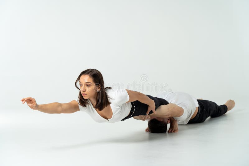 Premium Photo  Duo of male and female acrobats showing hand to hand trick,  isolated on white