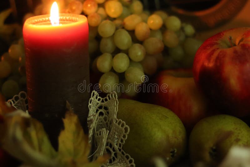 Durata del raccolto autunnale Calore della casa accogliente Fiamma di candela e composizione della frutta: mele rosse, pere verdi immagine stock Durata del raccolto autunnale Calore della casa accogliente Fiamma di candela e composizione della frutta: mele rosse, pere verdi immagine stock