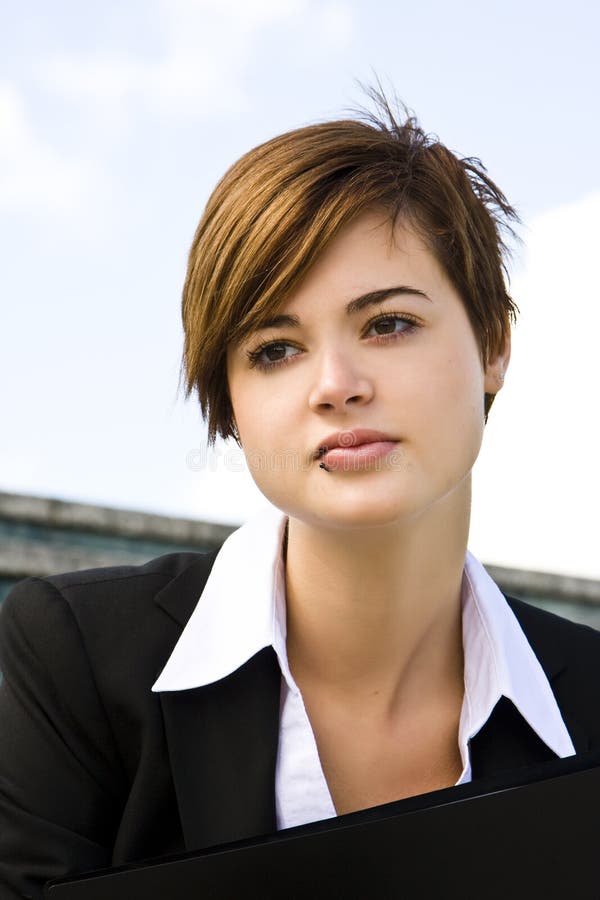 Short haired businesswoman over blue sky. Short haired businesswoman over blue sky.