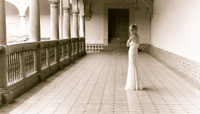 Thoughtful woman in classic interior building, sepia toned. Thoughtful woman in classic interior building, sepia toned.