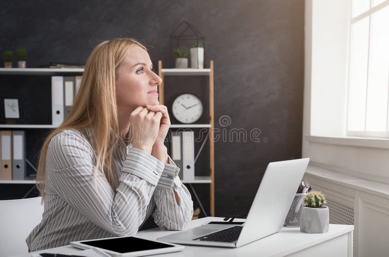 Durchdachte Geschäftsfrau, die an Laptop im Büro arbeitet stockbilder Durchdachte Geschäftsfrau, die an Laptop im Büro arbeitet stockbilder