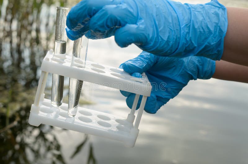 Taking a water test for analysis from a reservoir. Taking a water test for analysis from a reservoir