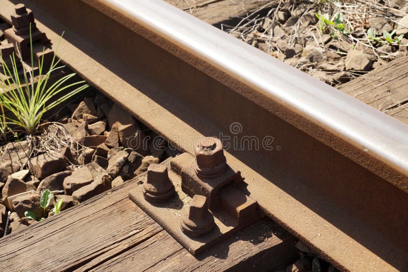 Durmiente ferroviario de madera Carriles sujetados con los tornillos al durmiente ferroviario fotografía de archivo libre de regalías Durmiente ferroviario de madera Carriles sujetados con los tornillos al durmiente ferroviario fotografía de archivo libre de regalías