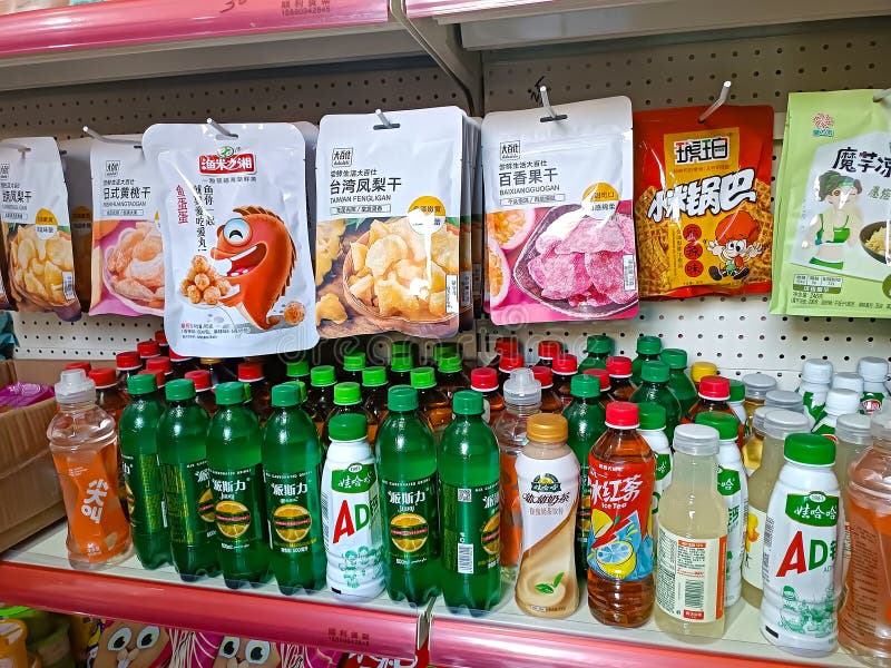 Different Chinese sweet snack packages and drinks bottles on the display shelf in the supermarket close up royalty free stock images Different Chinese sweet snack packages and drinks bottles on the display shelf in the supermarket close up royalty free stock images