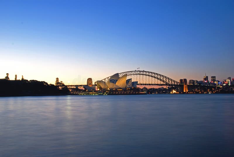 Sydney Harbour Sky Line At Night, NSW, Australia, Oceania. The Sydney harbour bridge and sydney opera house sparkling in the night. Colourful surface. Night scene, panorama. Sydney Harbour Sky Line At Night, NSW, Australia, Oceania. The Sydney harbour bridge and sydney opera house sparkling in the night. Colourful surface. Night scene, panorama