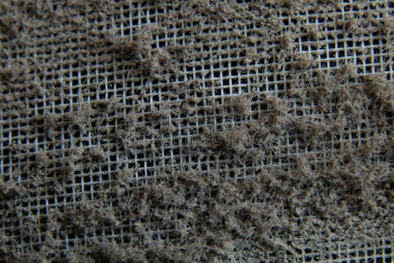 Dust on the protective mesh of the air conditioner as a background macro photo