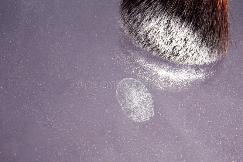 Fingerprint on a blotter with a dusting brush. Fingerprint on a blotter with a dusting brush