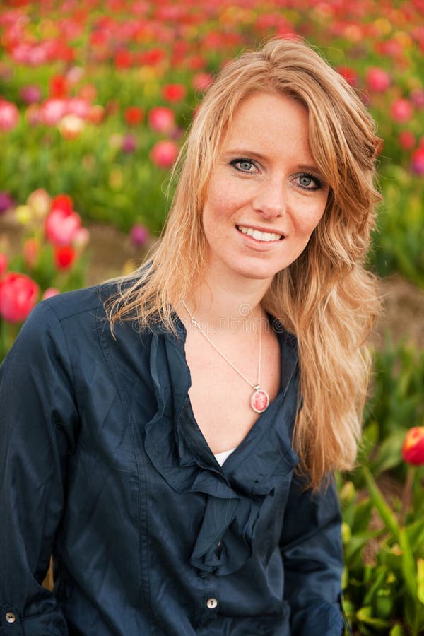 Dutch blond girl in field with tulips
