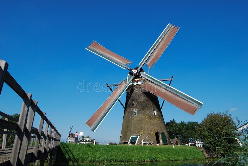 Dutch mill on the waterside royalty free stock photography