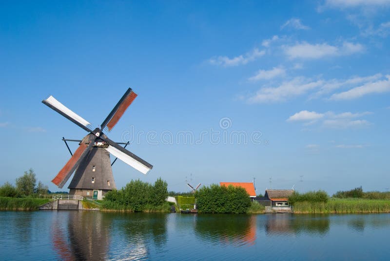 Dutch mill at the waterside royalty free stock photo