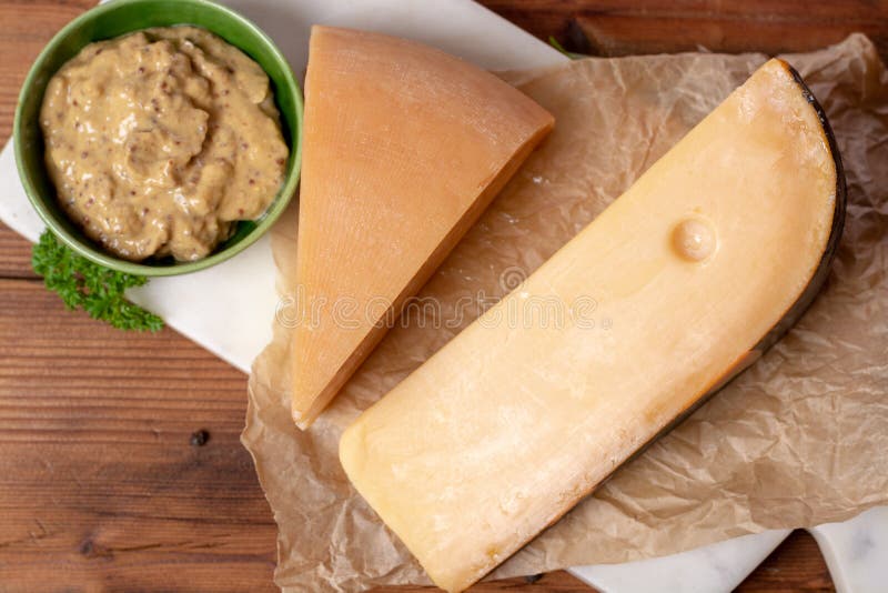 Dutch Old Cheeses, Made from Cow and Goat Milk on White Table Stock