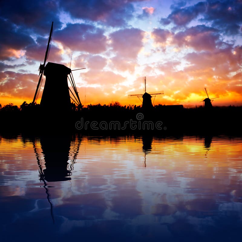 Dutch windmills reflecting on water