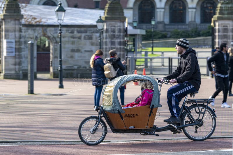 Cyclist rushing back home on dolly cargo bike royalty free stock image Cyclist rushing back home on dolly cargo bike royalty free stock image