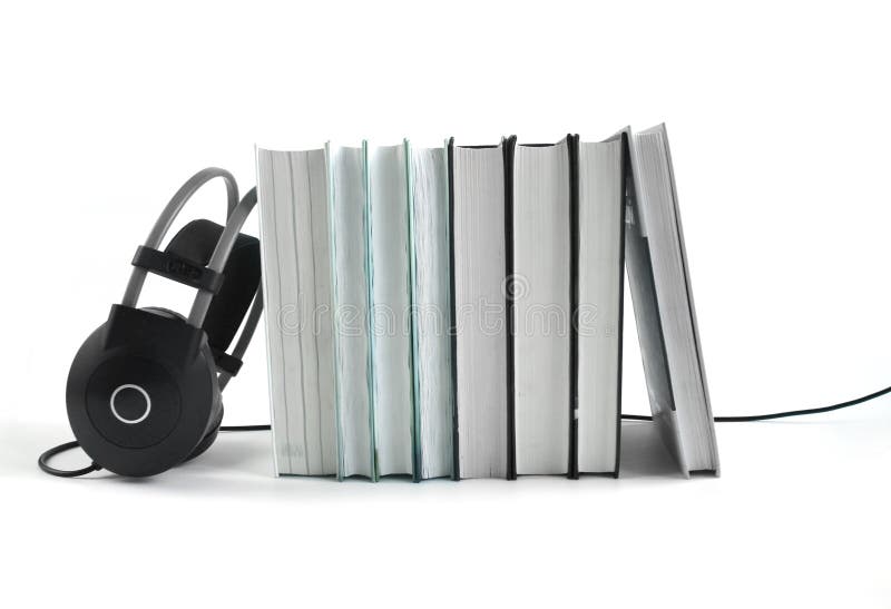 Big black headphones near the stack of books on white background. Audio book concept. Copy space for text. Big black headphones near the stack of books on white background. Audio book concept. Copy space for text