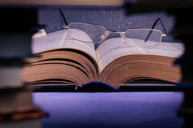 Big book on the table through a stack of books with a place for text, writer day, poet, library. Big book on the table through a stack of books with a place for text, writer day, poet, library