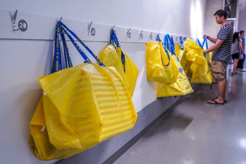 Duże żółte torby na zakupy w IKEA przechują obwieszenie na białych ścianach fotografia royalty free