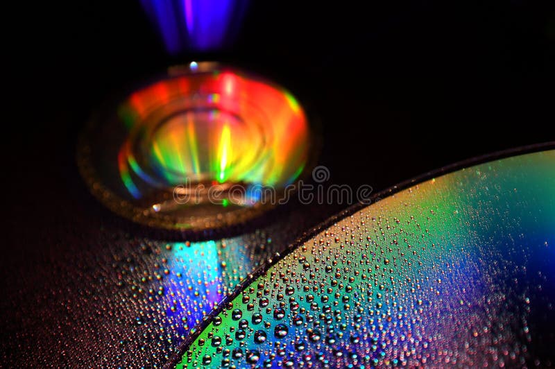 DVD and CD disc with water drops colour background. royalty free stock photos DVD and CD disc with water drops colour background. royalty free stock photos