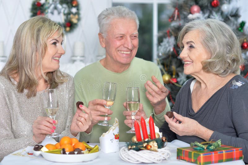 Two mature women and men celebrating new year. Two mature women and men celebrating new year