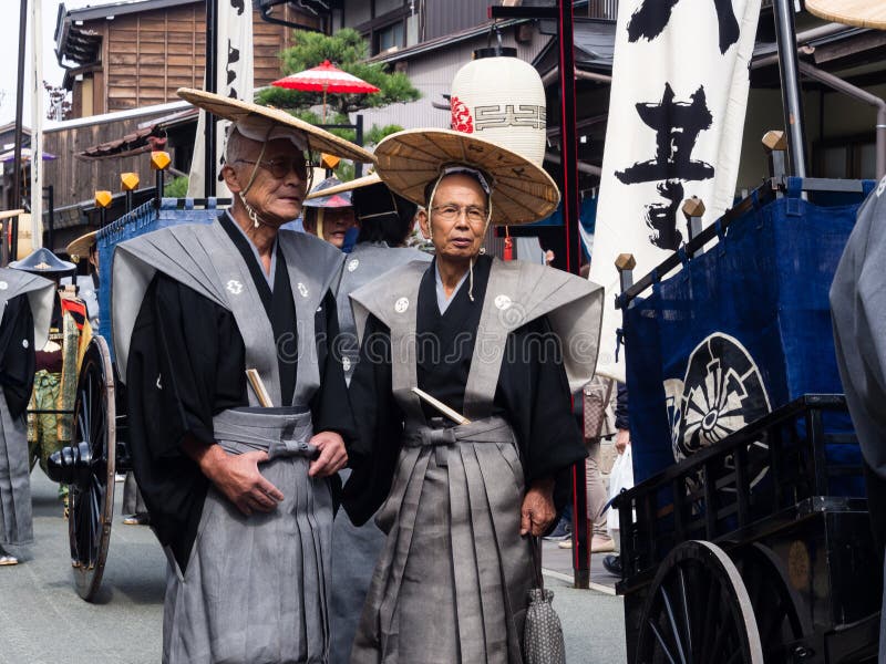 Takayama, Japan - October 10, 2015: Local people dressed as samurai marching the streets of historic Takayama during the annual Takayama Autumn Festival parade. Takayama, Japan - October 10, 2015: Local people dressed as samurai marching the streets of historic Takayama during the annual Takayama Autumn Festival parade