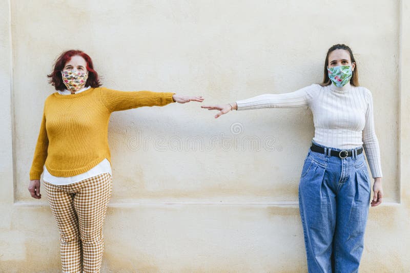 Two woman with face masks representing a social distancing. Two woman with face masks representing a social distancing