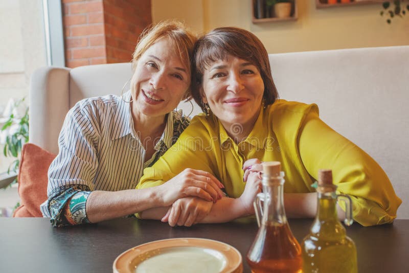 Two happy mature women in restaurant. Two happy mature women in restaurant.