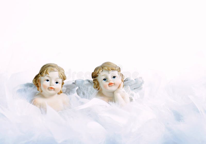 Two beautiful small cherub in feathers. Two beautiful small cherub in feathers