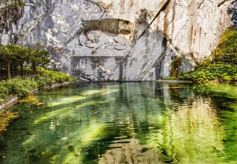 Dying Lion Rock Reflief Reflection Cliff Lucerne Switzerland Created in 1821 by Bertel Thorvaldsen. Monument Swiss guards killed in 1792 protecting king French Revolution. Dying Lion Rock Reflief Reflection Cliff Lucerne Switzerland Created in 1821 by Bertel Thorvaldsen. Monument Swiss guards killed in 1792 protecting king French Revolution