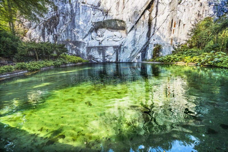 Dying Lion Rock Reflief Reflection Cliff Lucerne Switzerland Created in 1821 by Bertel Thorvaldsen. Monument Swiss guards killed in 1792 protecting king French Revolution. Dying Lion Rock Reflief Reflection Cliff Lucerne Switzerland Created in 1821 by Bertel Thorvaldsen. Monument Swiss guards killed in 1792 protecting king French Revolution