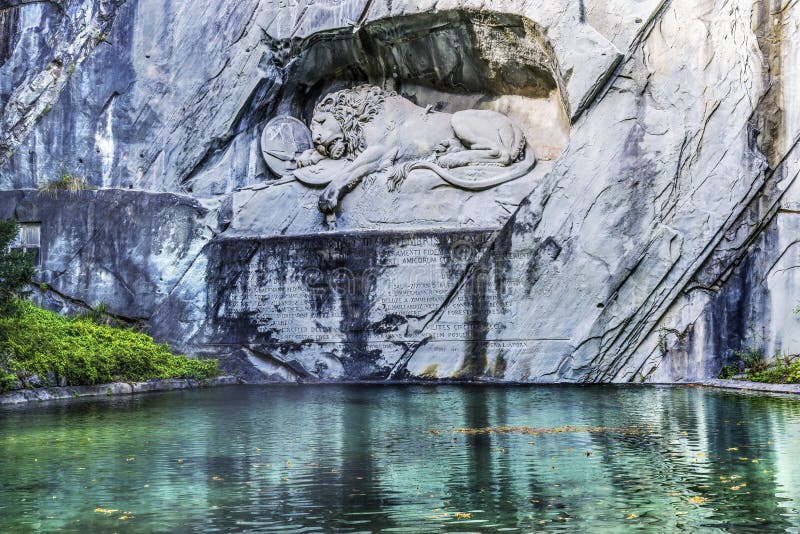 Dying Lion Rock Reflief Reflection Cliff Lucerne Switzerland Created in 1821 by Bertel Thorvaldsen. Monument Swiss guards killed in 1792 protecting king French Revolution. Dying Lion Rock Reflief Reflection Cliff Lucerne Switzerland Created in 1821 by Bertel Thorvaldsen. Monument Swiss guards killed in 1792 protecting king French Revolution