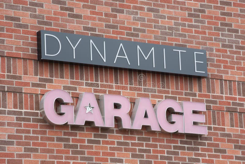 DARTMOUTH, CANADA - JULY 24, 2016: Dynamite Garage clothing store sign. Groupe Dynamite is a Canada based clothing company founded in 1975. DARTMOUTH, CANADA - JULY 24, 2016: Dynamite Garage clothing store sign. Groupe Dynamite is a Canada based clothing company founded in 1975.