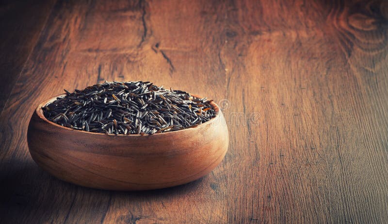 Wild rice in a wooden bowl. Wild rice in a wooden bowl