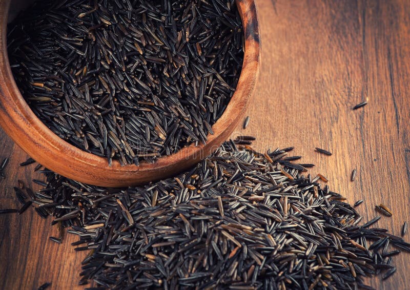 Wild rice in a wooden bowl. Wild rice in a wooden bowl