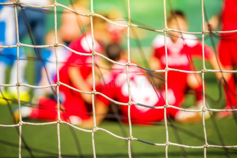 Kids soccer team celebrate goal and victory, defocussed blur sport background image. Kids soccer team celebrate goal and victory, defocussed blur sport background image