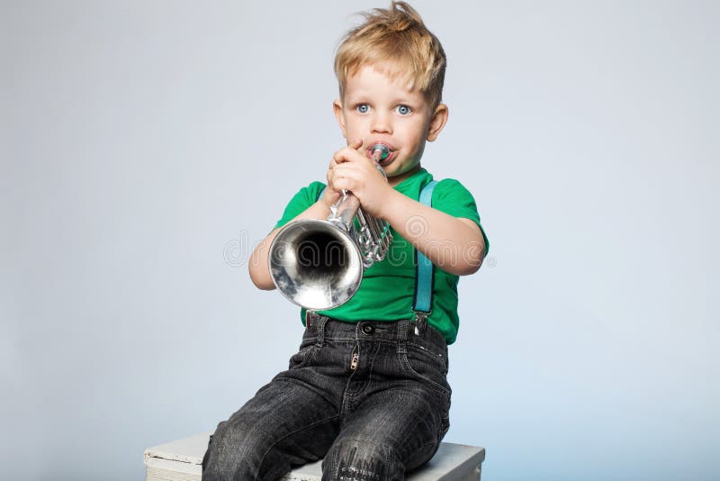 Isolated Young Boy Blowing Trumpet. Isolated Young Boy Blowing Trumpet