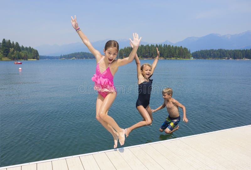 Dzieciaki bawić się przy jeziorem na ich wakacje