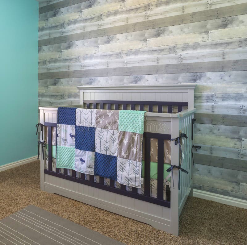 Baby crib for new born in a modern home with accent wall. Baby crib for new born in a modern home with accent wall