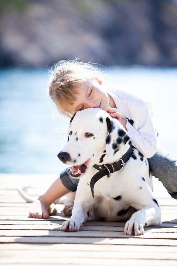 Happy babygirl with her dog on berth in summer. Happy babygirl with her dog on berth in summer