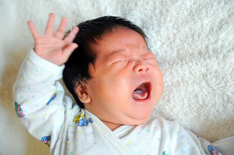 A one month old Asian baby boy crying. A one month old Asian baby boy crying